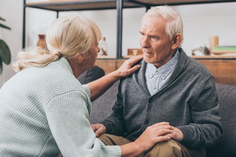 retired-couple-holding-hands-and-looking-at-each-o-HJ657Z7