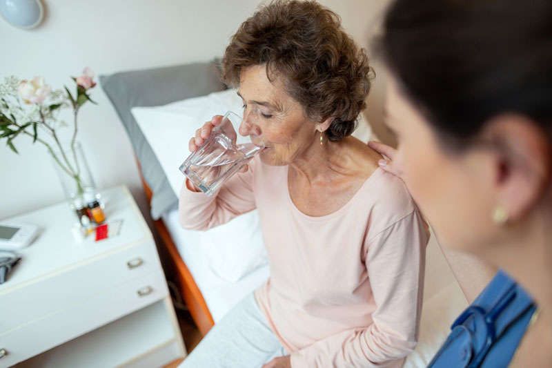 elderly woman patient receiving hospice medical care medication