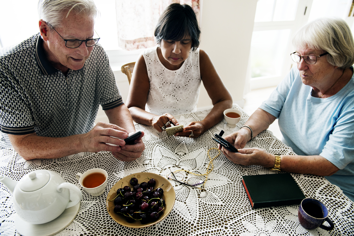 group of senior people using mobile phone