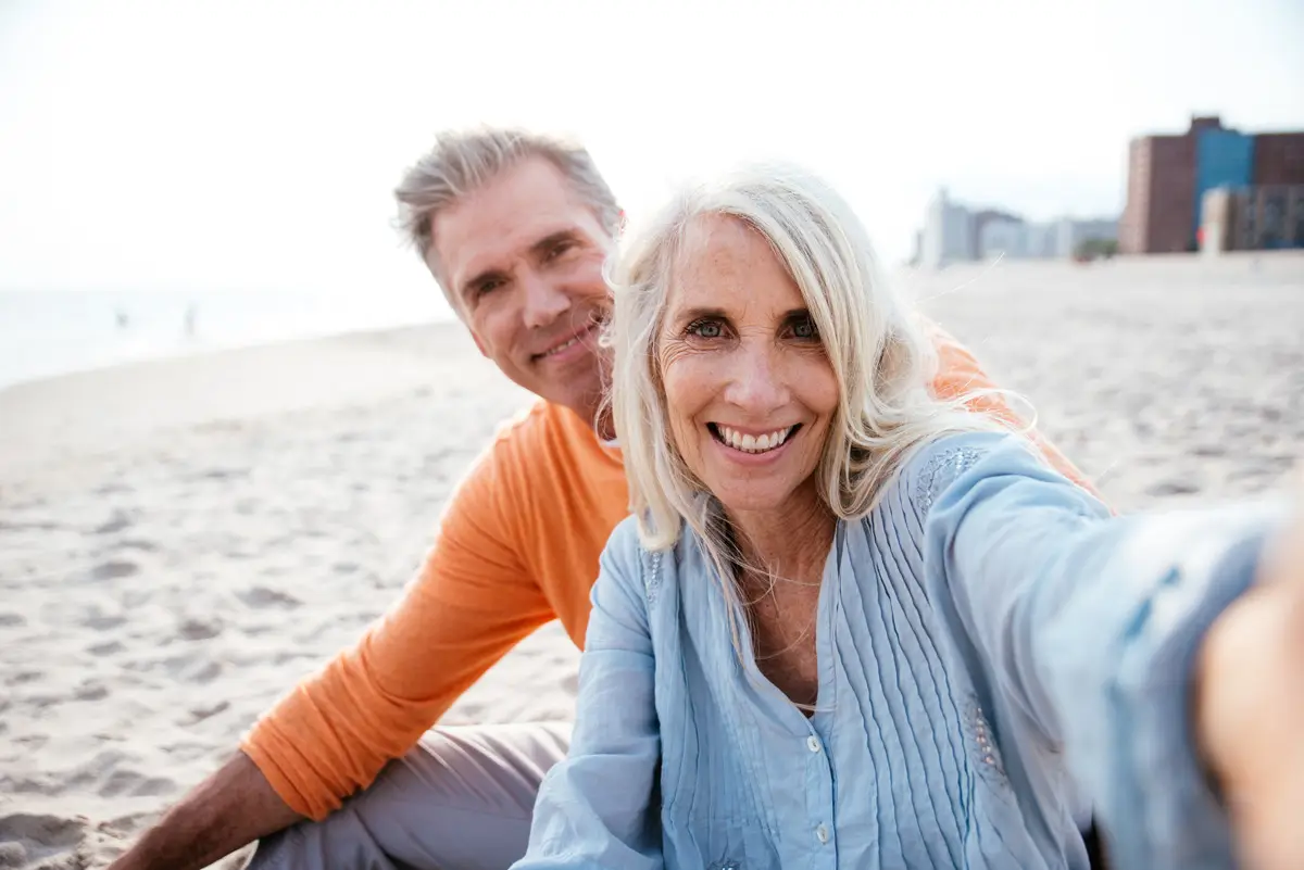 happy senior couple spending time at the beach in la