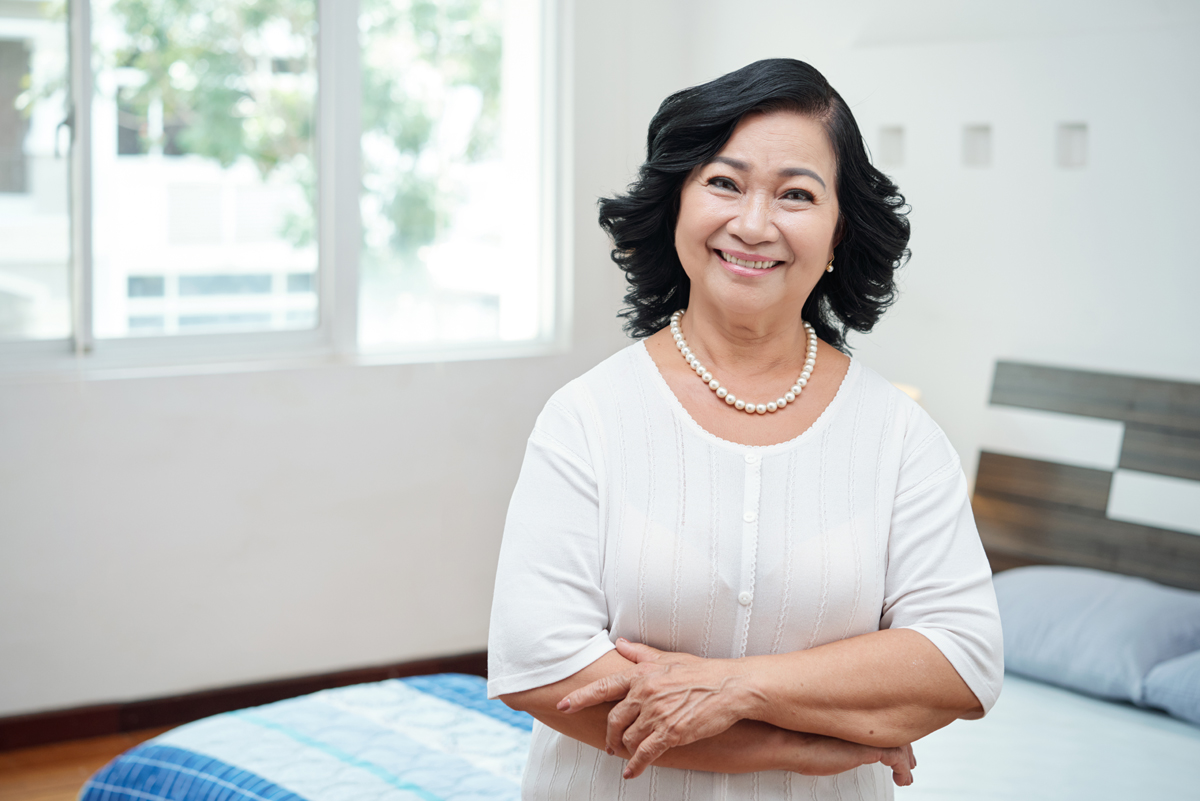 happy senior woman in elderly subsidized apartment